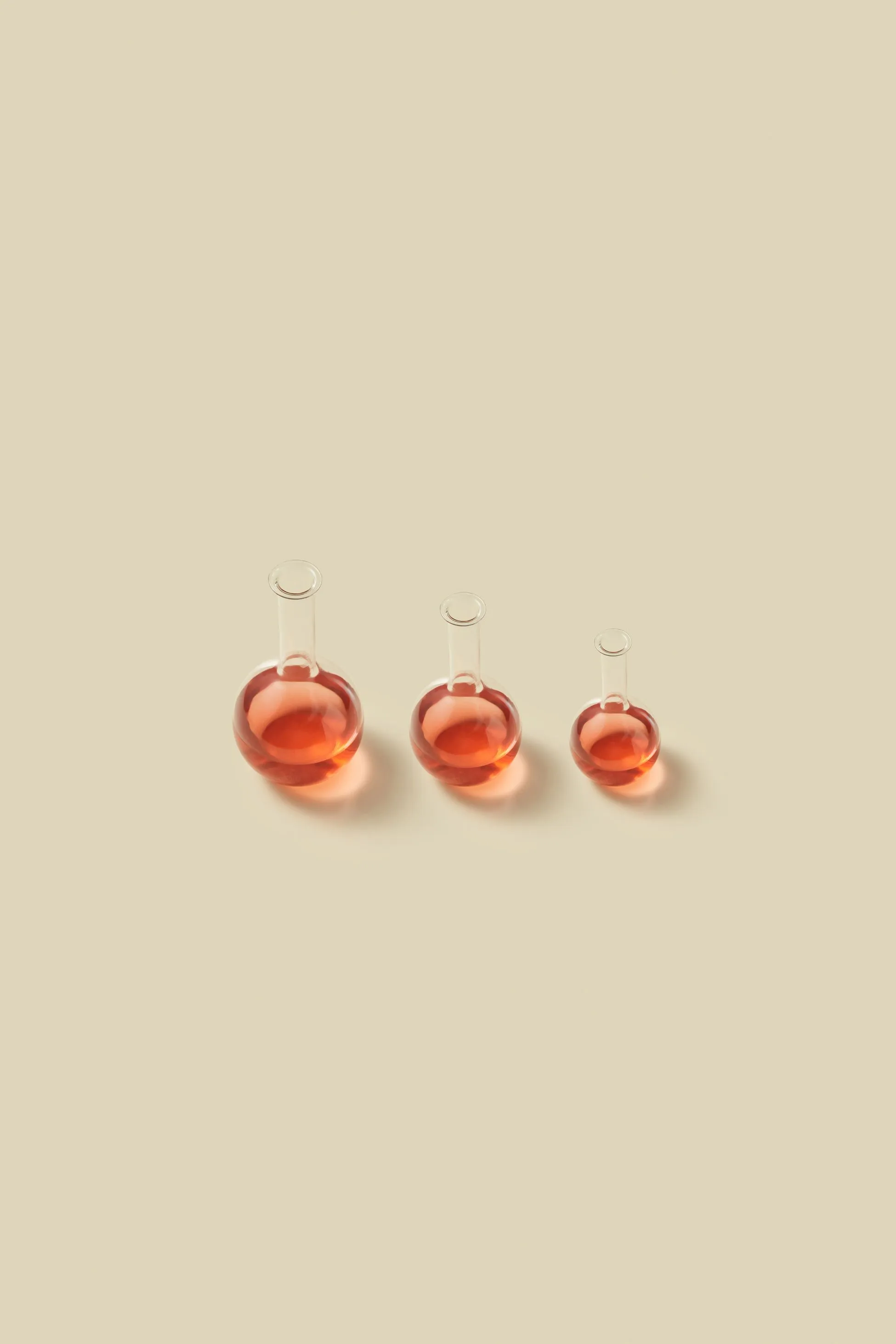 round vials of reddish liquid